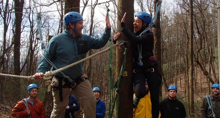 adults learn rock climbing skills in blue ridge mountains